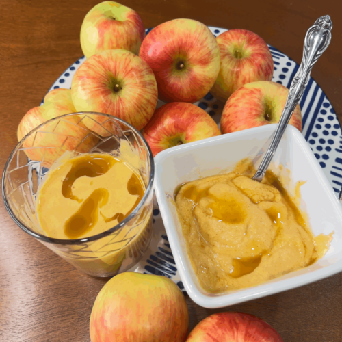 apples on table with smoothie in a glass and smoothie in a bowl