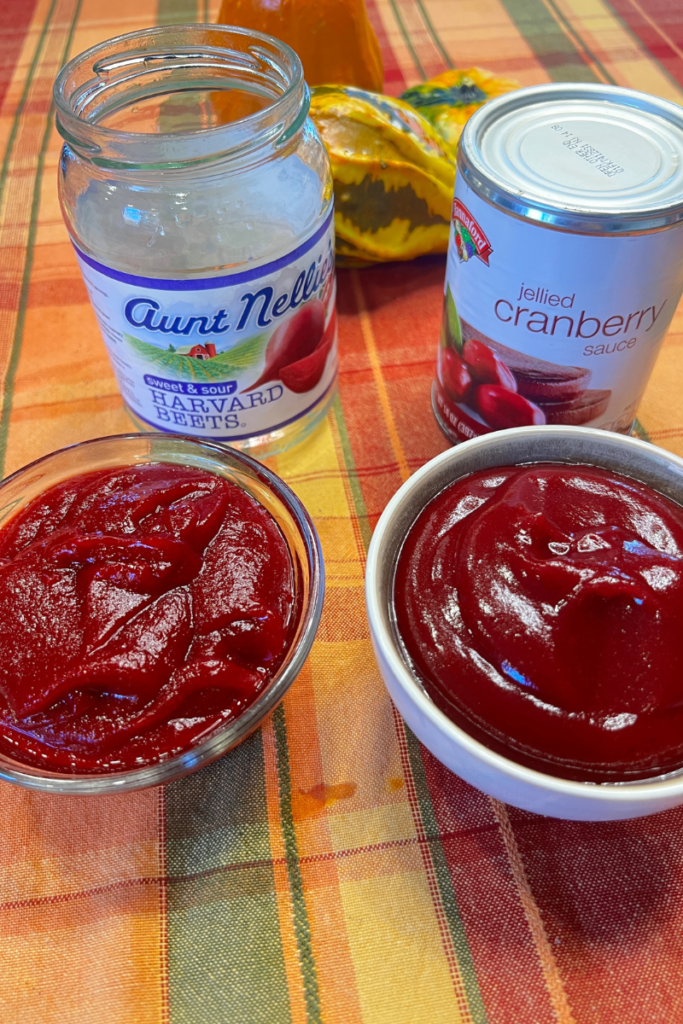 Bottle of aunt nellie's Harvard beets and Hannaford jellied cranberry sauce with bowls in front of the bowls of each food pureed